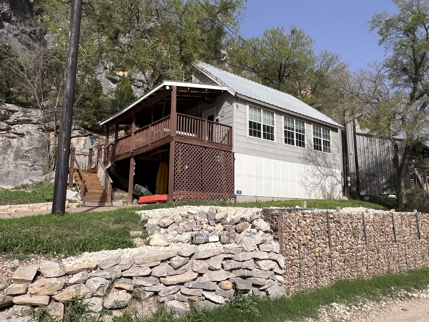 Cottage exterior with limestone canyon cliff rising behind