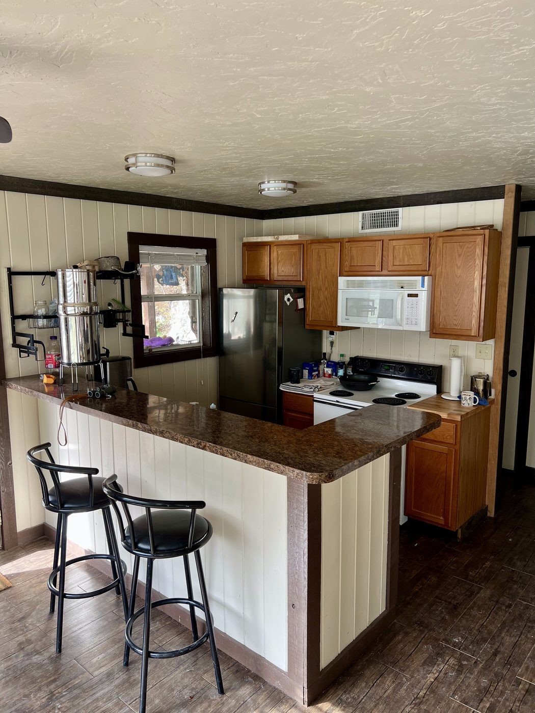 Full kitchen with bar seating and granite countertops